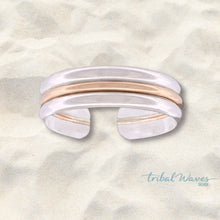 Load image into Gallery viewer, gold and silver toe ring floating over a tan sand background.