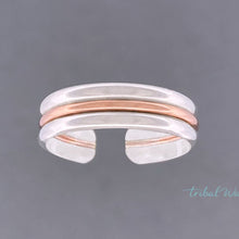 Load image into Gallery viewer, toe ring with two bands of silver and a band of rose gold in the center floating over a grey background.